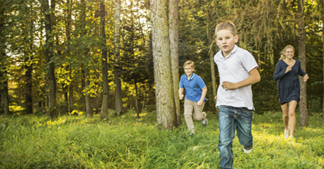 Kids running through the forest